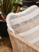 Teepee Performance Trim is wrapped around Bookend-covered cushion, this passementerie transforms your outdoor space into a luxurious, vibrant retreat—blending durability with fun and elegance. Perfect for both indoors and out.